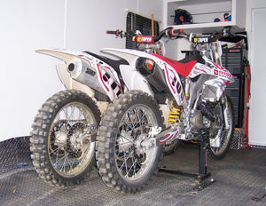 Two Honda mx bikes loaded into an RV with the Lock-N-Load Moto Transport System. No messy straps needed